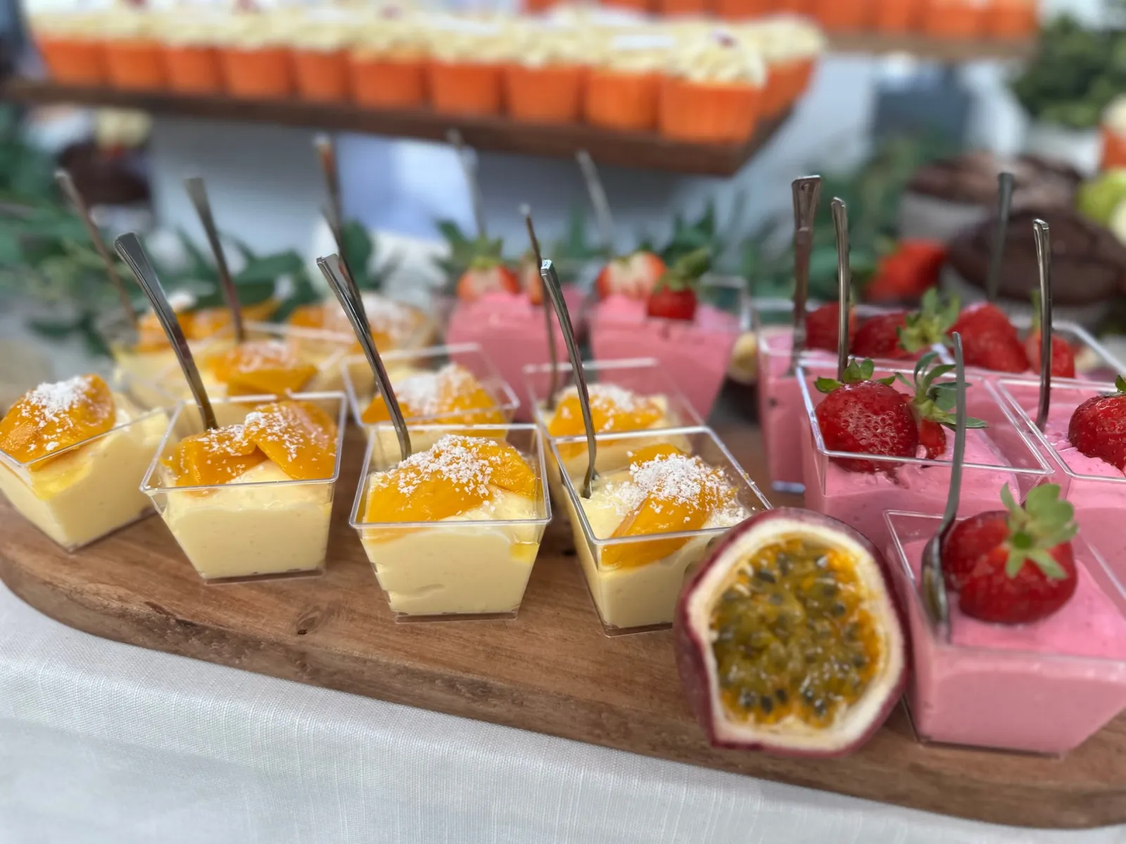 Mango and strawberry mousse dessert cups with fresh passionfruit, prepared by the UNISUS catering team